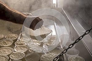 Process of making fresh white soft ricotta whey cheese on small cheese farm in Parma, Italy