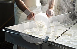 Process of making fresh white soft ricotta whey cheese on small cheese farm in Parma, Italy