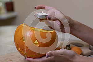 the process of making a Halloween pumpkin. lighted candle. horror theme and Hallowe`en