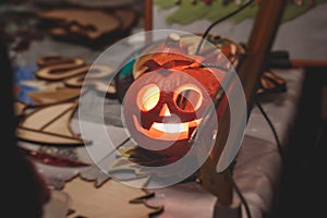 Process of making pumpkin lantern for halloween party, glowing jack-o-lantern carving master class on halloween fair market,