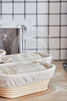 Process of making wheat bread at home. Proofing of the dough in rattan baskets. The concept of healthy homemade food.