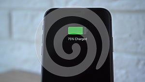 Process of mobile phone charging on an induction station pad. 4k stock footage.