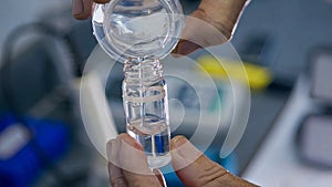 Process of packaging chemical solutions in glass bottles