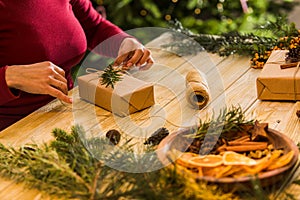 Process of packing Christmas gift boxes with natural materials