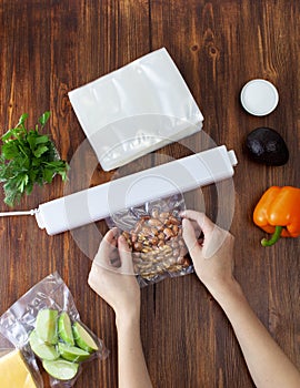 The process of packing nuts in a vacuum bag and sealing with a vacuum cleaner