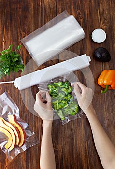 The process of packing pieces of fresh broccoli in a vacuum bag and sealing