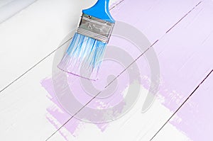 Process of painting the wood boards with brush and violet color