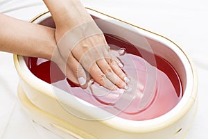 Process paraffin treatment of female hands photo