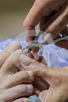 Process of pedicure at beauty salon. Manicurist work on a woman client feet, make her nails look beautiful. Salon pedicure