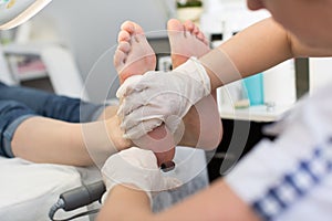 Process pedicure close-up, polishing feet. Pedicure SPA procedure in the beauty salon.
