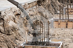 The process of pouring concrete into the formwork with rebar. Construction site, details