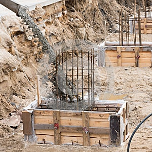 The process of pouring concrete into the formwork with rebar. Construction site, details