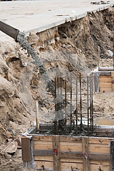 The process of pouring concrete into the formwork with rebar. Construction site, details