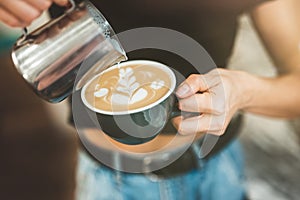 Process of pouring whipped cream to hot coffee drink , barista work close up