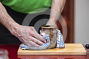 Process of preparation homemade pork stew. Canned pork meat in jar