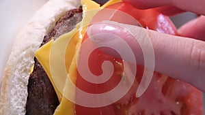 process of preparing a burger American food fast food at home bun mustard put the cutlet spread the sauce press the