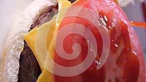 process of preparing a burger American food fast food at home bun mustard put the cutlet spread the sauce press the