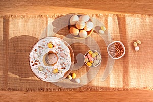 The process of preparing and decorating an Easter cupcake in the kitchen with white cream