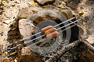 Process of preparing delicious sausages on coals in nature