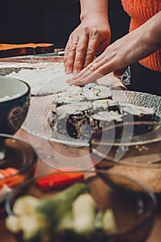 The process of preparing sushi from rice and additional ingredients at home