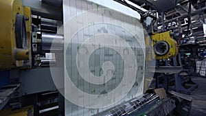 The process of producing wallpaper, printing on wallpaper, conveyor at the factory for the production of wallpaper