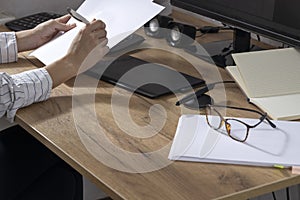 Process of product build concept.Woman holding documents and pen,analyzing information for design development. Graphics tablet,pap