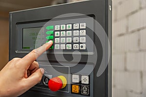 The process of programming a CNC machine. Entering data into a computer controlled machine. CNC machine operator enters data
