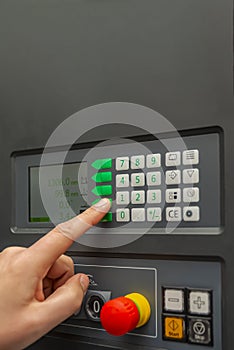 The process of programming a CNC machine. Entering data into a computer controlled machine. CNC machine operator enters