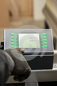 The process of programming a CNC machine. Entering data into a computer controlled machine. CNC machine operator enters