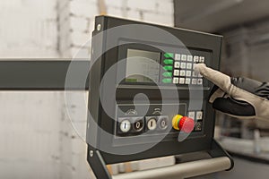 The process of programming a CNC machine. Entering data into a computer controlled machine, starting CNC engraving, control screen