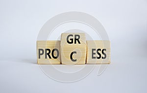 Process and Progress symbol. Wooden cubes with words Process and Progress. Beautiful white background. Business and Process and