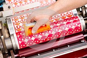 Process of removing possible dust debris on polymer plate in magenta print tower station with sticky roll on flexographic press.