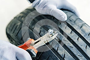 The process of removing a screw from a car tire. Puncture of a wheel on the road. Close-up