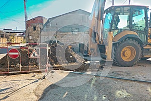 The process of repair and restoration of the operability of the underground utilities section. Excavator dug trench over