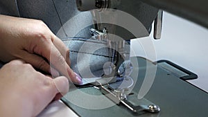 Process of sewing leather goods. The needle of the sewing machine in motion. two needles of the sewing machine quickly