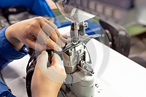 The process of sewing shoes on a sewing machine. Shoe production