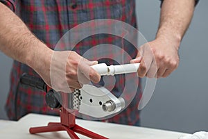 The process of soldering plastic pipes.