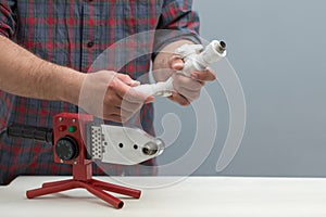 The process of soldering plastic pipes.