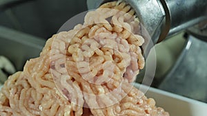 The process of squeezing minced meat from a meat grinder, processing white meat into minced meat for meatballs on a food