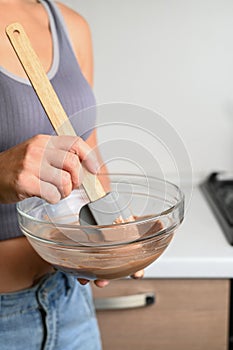 The process of tempering chocolate and making chocolates. Pastry chef using spatula tempering molten chocolate