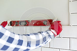 Process of tiling the tiles in the kitchen. Contractor measuring