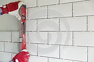 Process of tiling the tiles in the kitchen. Contractor measuring