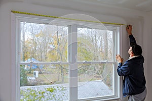 Process for under construction measuring and nailing moldings on the window in a new home