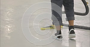 The process of vacuuming a polymer floor after finishing work. Cleaning the construction site from dust. A builder