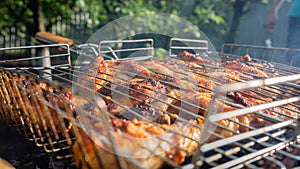 Processcooking chicken legs and chicken breast on a barbecue grill outdoors. Picnic, eating outdoors. Metal barbecue