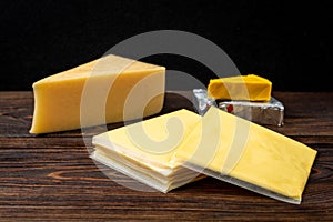 Processed cheese on dark wooden background