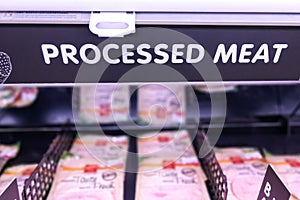 Processed Meat signage at the meat section of supermarket with defocused background