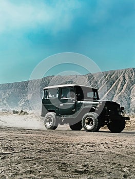 a jeep in the middle of the desert - Mount Bromo - Indonesia photo