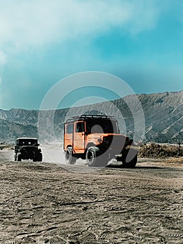 a jeep in the middle of the desert - Mount Bromo - Indonesia photo