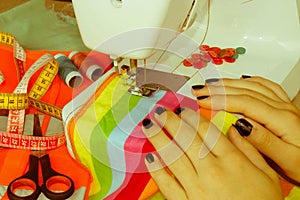 Processes of sewing on the sewing machine sew women`s hands sewi